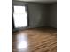 Bedroom with wood floors and bright window with sheer curtains at 3619 31St St, Columbus, IN 47203