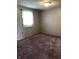 Cozy bedroom features plush carpet, neutral walls, natural light, and a standard light fixture at 3619 31St St, Columbus, IN 47203