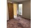Bedroom features cozy carpet flooring and view to an adjacent full bathroom at 3619 31St St, Columbus, IN 47203