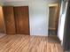 Bedroom with wood floors, closet with wood doors and bathroom access at 3619 31St St, Columbus, IN 47203