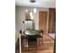 Bright dining area featuring wood floors, a pendant light, and a view into the kitchen at 3619 31St St, Columbus, IN 47203