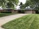 Charming brick ranch-style home with well-manicured lawn and attached two-car garage at 3619 31St St, Columbus, IN 47203