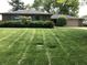 Exterior showcases a brick ranch-style home, lush green grass, and landscaping with blue shutter accents at 3619 31St St, Columbus, IN 47203