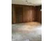 Spacious living room offers comfortable carpeting, wood paneling, and a wall-mounted light fixture at 3619 31St St, Columbus, IN 47203