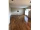 An empty living room features hardwood floors and a ceiling light fixture, awaiting personal touches at 3619 31St St, Columbus, IN 47203