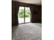 Living room featuring a sliding glass door to the backyard and cozy carpeting at 3619 31St St, Columbus, IN 47203