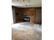 The carpeted living room features a brick fireplace and wood-paneled walls, offering a cozy atmosphere at 3619 31St St, Columbus, IN 47203