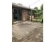 Concrete patio with brick trim and a wooden swing set against the brick exterior of the home at 3619 31St St, Columbus, IN 47203