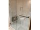 Accessible shower featuring grab bars and fold-down seat with white tiled walls at 3619 31St St, Columbus, IN 47203