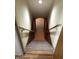 Carpeted stairwell with wooden handrail, leading to finished basement at 3619 31St St, Columbus, IN 47203