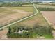 Aerial view of property showcasing its expansive land and proximity to fields at 3868 E Worthsville Rd, Whiteland, IN 46184