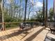 The back deck has seating and a view of the surrounding trees and inground pool at 3868 E Worthsville Rd, Whiteland, IN 46184