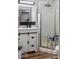Bathroom with vanity, a glass shower, and a modern black tiled backsplash at 3868 E Worthsville Rd, Whiteland, IN 46184