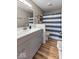 Bathroom featuring a vanity, mirror, towel rack, and shower with a blue and white striped curtain at 3868 E Worthsville Rd, Whiteland, IN 46184