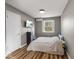 Bedroom featuring wood-look flooring, a television and a large window at 3868 E Worthsville Rd, Whiteland, IN 46184