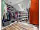 Organized walk-in closet with custom shelving for clothes, shoes, and accessories with a skylight at 3868 E Worthsville Rd, Whiteland, IN 46184