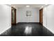 A clean, empty room with black floors, white walls, and natural light coming in from the window at 3868 E Worthsville Rd, Whiteland, IN 46184
