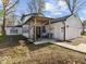 Quaint home exterior with covered porch and wooden beam, offering a welcoming curb appeal at 3868 E Worthsville Rd, Whiteland, IN 46184