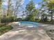 Inviting backyard pool area, framed by a secure fence and lush trees, offering privacy at 3868 E Worthsville Rd, Whiteland, IN 46184