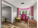 room with wood-look flooring, bright pink walls and a bay window at 3868 E Worthsville Rd, Whiteland, IN 46184