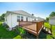 A view of the back deck, lawn, and back of the house on a sunny day at 40 Clear Spring Ln, Trafalgar, IN 46181