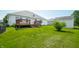 A sunny backyard with healthy grass, a deck and a storage shed at 40 Clear Spring Ln, Trafalgar, IN 46181
