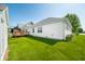 This backyard with a lawn features the house, a deck, and plantings at 40 Clear Spring Ln, Trafalgar, IN 46181