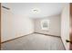 A clean and carpeted bedroom with a window and neutral colored walls at 40 Clear Spring Ln, Trafalgar, IN 46181