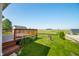 Wooden deck with flower garden, a partial view of a hot tub and scenic views of green field and clear blue sky at 40 Clear Spring Ln, Trafalgar, IN 46181