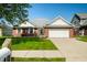 Lovely one-story home featuring a brick facade, white trim, and a spacious driveway at 40 Clear Spring Ln, Trafalgar, IN 46181