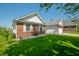 Well-maintained home showcasing brick and siding, a lush lawn, and a side-entry garage at 40 Clear Spring Ln, Trafalgar, IN 46181