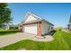 Charming home with a side-entry garage, lush lawn, and manicured landscaping at 40 Clear Spring Ln, Trafalgar, IN 46181