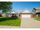 Charming single-story brick home with a two-car garage and well-manicured front lawn at 40 Clear Spring Ln, Trafalgar, IN 46181