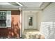 Entrance featuring a decorative glass door, white trim, and a brick accent wall at 40 Clear Spring Ln, Trafalgar, IN 46181