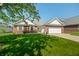 Beautiful single-story home with brick accents, well-maintained lawn, and mature trees at 40 Clear Spring Ln, Trafalgar, IN 46181