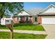 Attractive home with a tidy front lawn, brick accents, and a white mailbox near the sidewalk at 40 Clear Spring Ln, Trafalgar, IN 46181