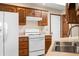 A kitchen featuring wood cabinets, white appliances, and a double sink at 40 Clear Spring Ln, Trafalgar, IN 46181