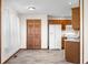 Open kitchen featuring wooden cabinets, a white refrigerator, and tile flooring at 40 Clear Spring Ln, Trafalgar, IN 46181