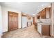 Spacious kitchen with wooden cabinets, white appliances, and a large storage closet at 40 Clear Spring Ln, Trafalgar, IN 46181