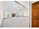 Bright living room boasts a fireplace, large windows, vaulted ceiling and plush carpet for a cozy atmosphere at 40 Clear Spring Ln, Trafalgar, IN 46181