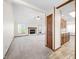 Spacious living room with fireplace and mantel offers a cozy focal point and access to the kitchen at 40 Clear Spring Ln, Trafalgar, IN 46181