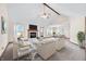 Staged living room with fireplace, plush seating, and an open layout seamlessly connects to the dining area at 40 Clear Spring Ln, Trafalgar, IN 46181