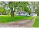 View of the house and a one-car garage with a yard at 42 E Brookville Rd, Fountaintown, IN 46130