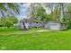 Backyard of a home with a deck and a detached one-car garage at 42 E Brookville Rd, Fountaintown, IN 46130
