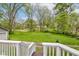 Spacious backyard with lush green grass, surrounded by trees, as seen from the deck's stairs at 42 E Brookville Rd, Fountaintown, IN 46130