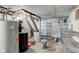 Unfinished basement featuring stairs, utilities, and shelving at 42 E Brookville Rd, Fountaintown, IN 46130