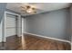 Cozy bedroom with ceiling fan, closet, and wood-look flooring at 42 E Brookville Rd, Fountaintown, IN 46130