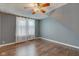 Cozy bedroom with hardwood floors, neutral paint, ceiling fan and bright window at 42 E Brookville Rd, Fountaintown, IN 46130