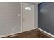 Entryway with hardwood flooring, half-moon window on the door, and neutral wall colors at 42 E Brookville Rd, Fountaintown, IN 46130