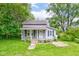 Charming gray two-story home with front porch and well-maintained lawn at 42 E Brookville Rd, Fountaintown, IN 46130